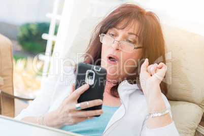 Shocked Middle Aged Woman Gasps While Using Her Smart Phone