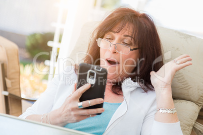 Shocked Middle Aged Woman Gasps While Using Her Smart Phone