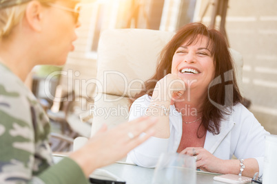 Two Female Friends Enjoying Conversation Outside