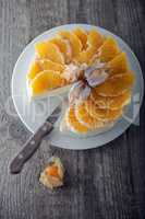 Cheesecake decorated with oranges and physalis.
