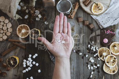 Open human palm on the background of the table with sweets