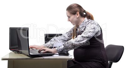 Working pregnant woman in office