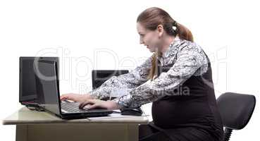 Working pregnant woman in office