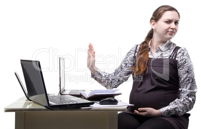 Frowned pregnant woman at work