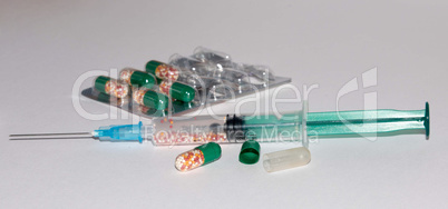Plastic Medical Syringe Isolated on White Background. Medications tablets and capsules.