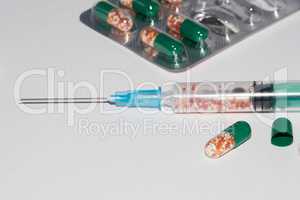Plastic Medical Syringe Isolated on White Background. Medications tablets and capsules.