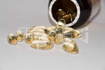Tabs Vitamins, omega 3, cod-liver oil, dietary supplement and tablets an embankment on a light background close up, the top view
