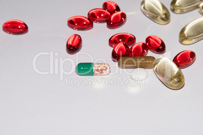 Tabs Vitamins, omega 3, cod-liver oil, dietary supplement and tablets an embankment on a light background close up, the top view