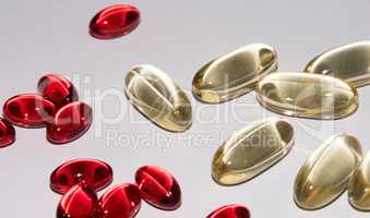 Tabs Vitamins, omega 3, cod-liver oil, dietary supplement and tablets an embankment on a light background close up, the top view