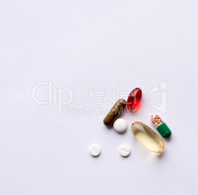 Tabs Vitamins, omega 3, cod-liver oil, dietary supplement and tablets an embankment on a light background close up, the top view