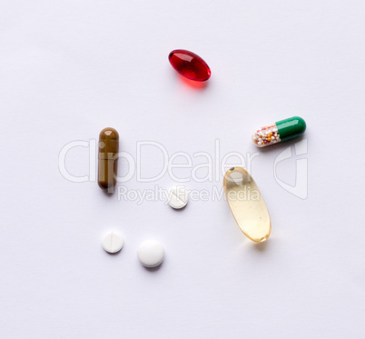 Tabs Vitamins, omega 3, cod-liver oil, dietary supplement and tablets an embankment on a light background close up, the top view