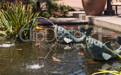 Relaxing zen fountain in a koi pond