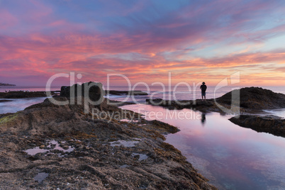 Lone man on the rocks at sunset at Treasure Island Beach