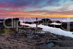 Lone man on the rocks at sunset at Treasure Island Beach