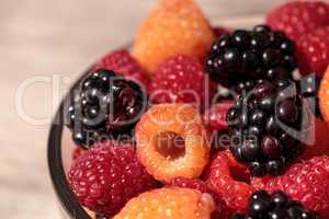 Organic golden and red raspberries mixed with blackberries