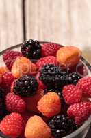 Organic golden and red raspberries mixed with blackberries