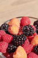 Organic golden and red raspberries mixed with blackberries