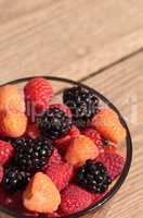 Organic golden and red raspberries mixed with blackberries