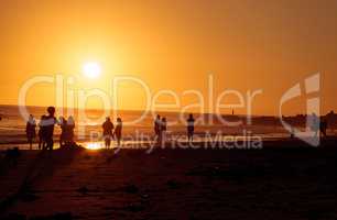 Silhouette of people enjoying the beach