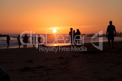 Silhouette of people enjoying the beach