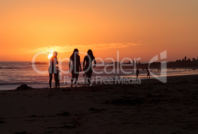 Silhouette of people enjoying the beach