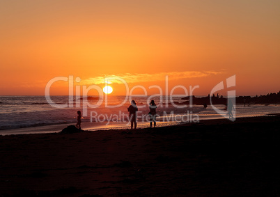 Silhouette of people enjoying the beach