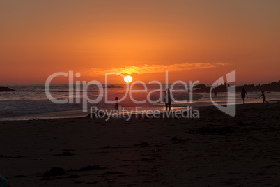 Silhouette of people enjoying the beach