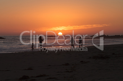 Silhouette of people enjoying the beach