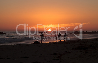 Silhouette of people enjoying the beach