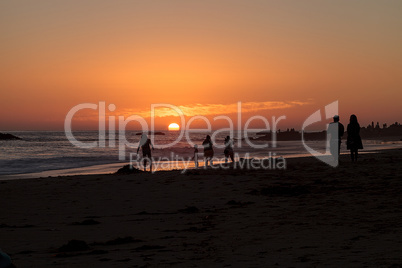 Silhouette of people enjoying the beach