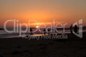 Silhouette of people enjoying the beach