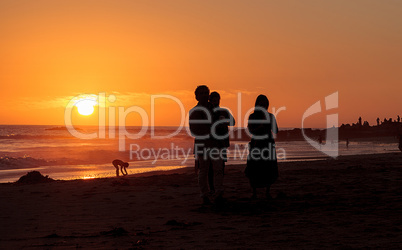 Silhouette of people enjoying the beach