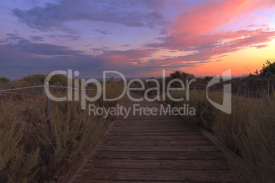 Boardwalk at Crystal Cove beach in California at sunset