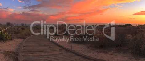 Boardwalk at Crystal Cove beach in California at sunset