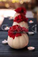 Red gerbera daisies in carved white Casper pumpkins