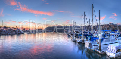 Sunset over sailboats in Dana Point harbor