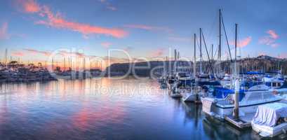 Sunset over sailboats in Dana Point harbor