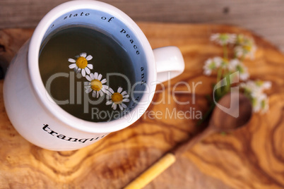 Chamomile tea with chamomile daisy flowers