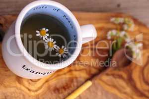 Chamomile tea with chamomile daisy flowers