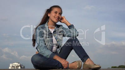 Happy Teen Girl Sitting Relaxing And Daydreaming