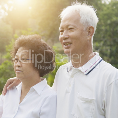 Asian seniors couple looking away