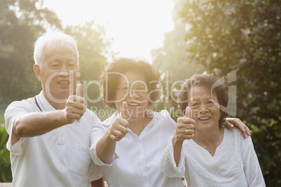 Group of Asian seniors giving thumbs up