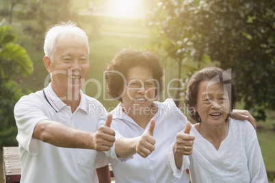Group of Asian seniors showing thumbs up