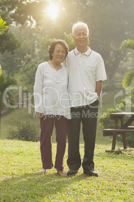 Asian seniors couple walking at outdoor park