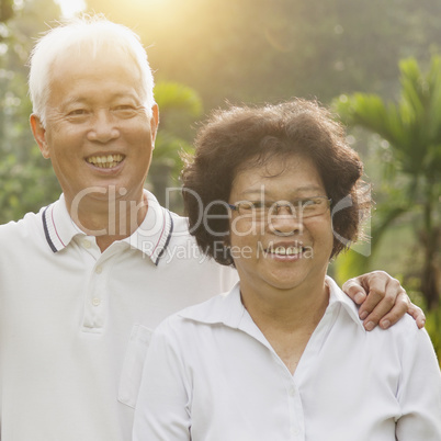 Loving Asian seniors couple outdoors