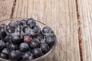 Clear glass bowl of ripe blueberries