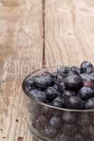 Clear glass bowl of ripe blueberries