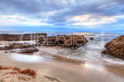 Sunset over the rocks at Pearl Street Beach