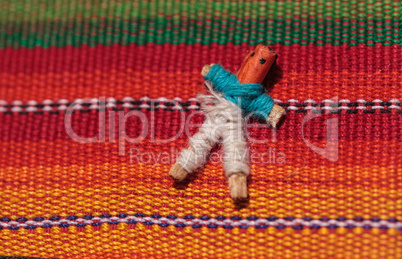 Macro of a handmade little textured Mexican cloth doll