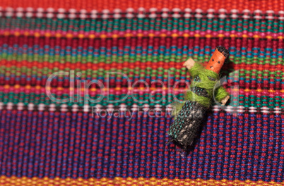 Macro of a handmade little textured Mexican cloth doll